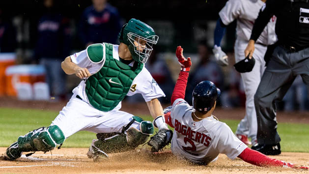 Apr 1, 2019; Oakland, CA, USA; Oakland Athletics catcher Nick Hundley (3) tags Boston Red Sox shortstop Xander Bogaerts (2) in a contested call that was upheld in the second inning at Oakland Coliseum. Photo Credit: John Hefti-USA TODAY Sports