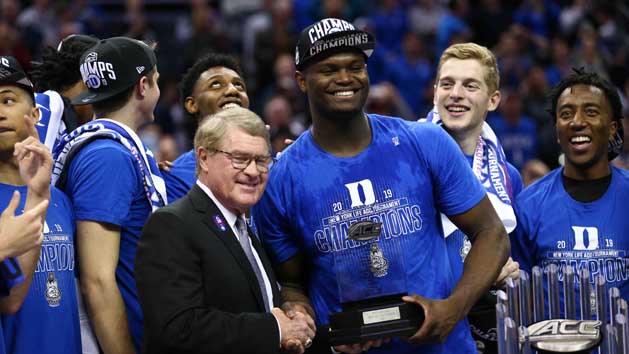 Mar 16, 2019; Charlotte, NC, USA; ACC Commissioner John Swofford presents Duke Blue Devils forward Zion Williamson (1) with the tournament MVP trophy in the ACC conference tournament at Spectrum Center. Photo Credit: Jeremy Brevard-USA TODAY Sports